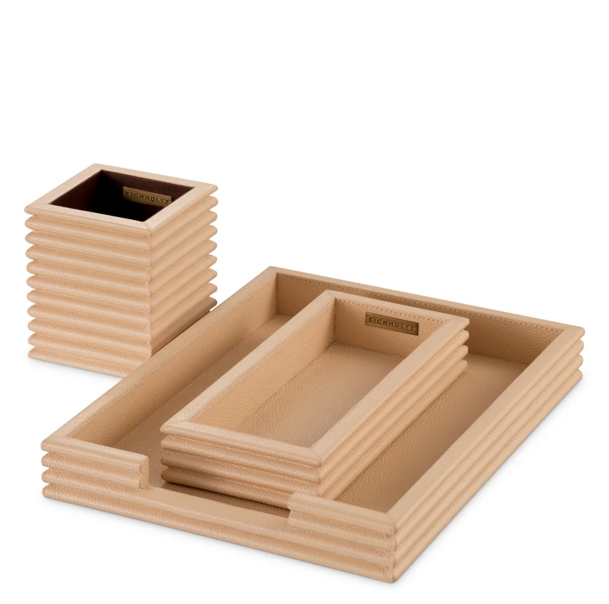 A luxurious Eichholtz Elvane three-piece desk set wrapped in genuine tan leather with textured concentric ridges, styled in a sophisticated home office setting by Eichholtz Los Angeles.