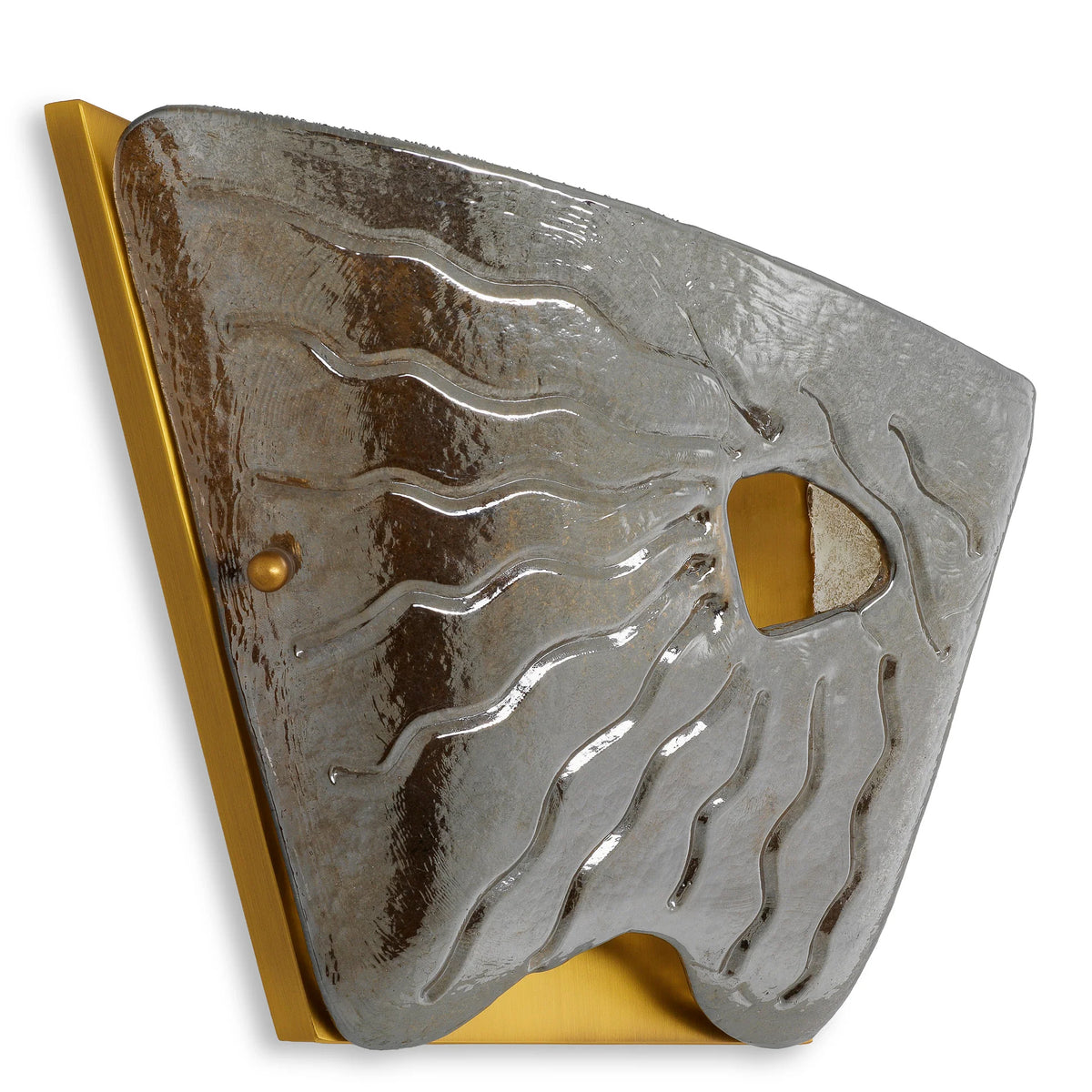 A sculptural Eichholtz Orlandis Left wall lamp featuring an asymmetrical smoke glass shield and antique brass finish, casting a warm amber glow in a luxury Eichholtz Los Angeles showroom