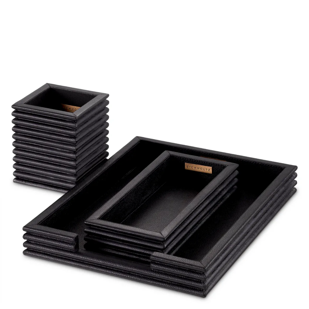 A luxurious Eichholtz Elvane three-piece desk set wrapped in genuine black leather with textured concentric ridges, styled in a sophisticated home office setting by Eichholtz Los Angeles.